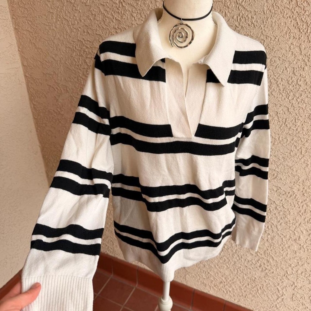 Black and white striped polo shirt with a preppy vibe